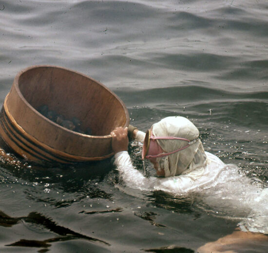 Ama Diver with bucket to hold her catch