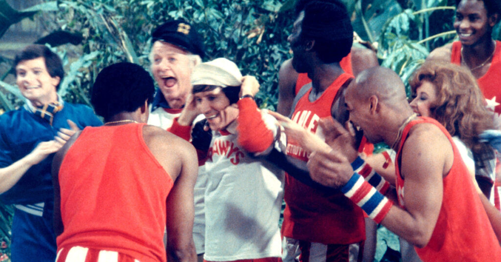 The cast of Gilligan's Island celebrates alongside members of the Harlem Globetrotters in a lively scene from The Harlem Globetrotters on Gilligan’s Island.