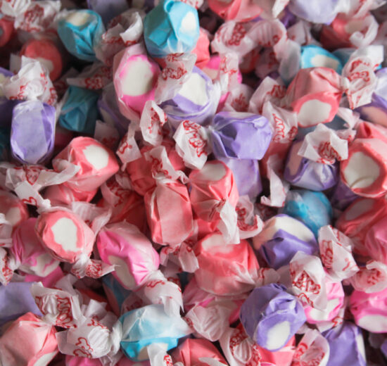 Colorful saltwater taffy candies in various pastel colors, individually wrapped.