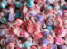 Colorful saltwater taffy candies in various pastel colors, individually wrapped.