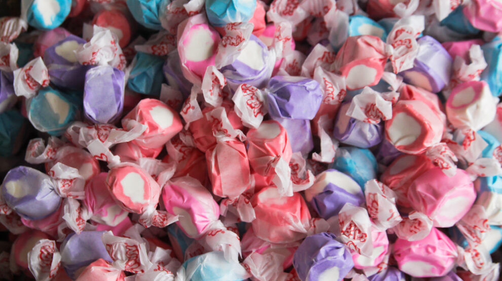 Colorful saltwater taffy candies in various pastel colors, individually wrapped.