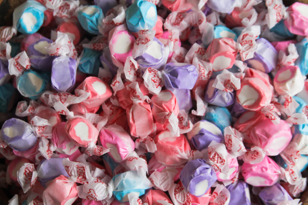 Colorful saltwater taffy candies in various pastel colors, individually wrapped.