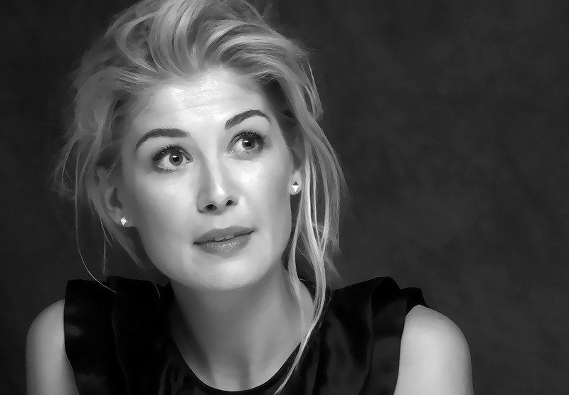 Black-and-white portrait of Rosamund Pike with styled hair and a thoughtful expression against a dark background.