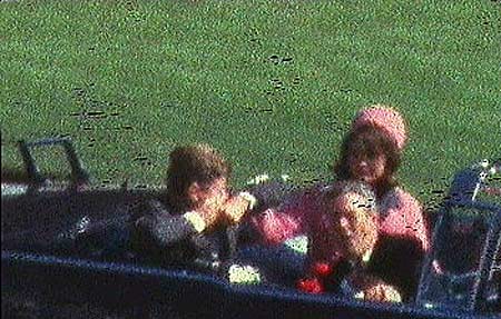  A grainy photo of President John F. Kennedy and First Lady Jacqueline Kennedy in the back of an open-top car during the Dallas motorcade.