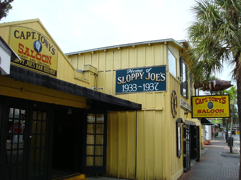 Capt. Tony's Saloon in Key West, Florida, featuring its yellow facade, original Sloppy Joe's sign, and connection to Captain Tony Tarracino and Jimmy Buffett's "Last Mango in Paris.