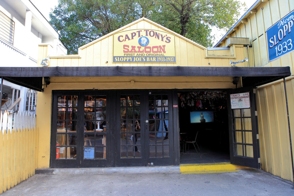The front facade of Capt. Tony's Saloon in Key West, Florida, featuring its iconic sign that reads "Capt. Tony's Saloon - First and Original Sloppy Joe's Bar 1933-1937." The saloon is famous for its connection to Jimmy Buffett and Captain Tony Tarracino.