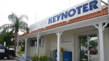 Florida Keys Keynoter building in Marathon, Florida, with a sign featuring the newspaper's name and a palm tree graphic.