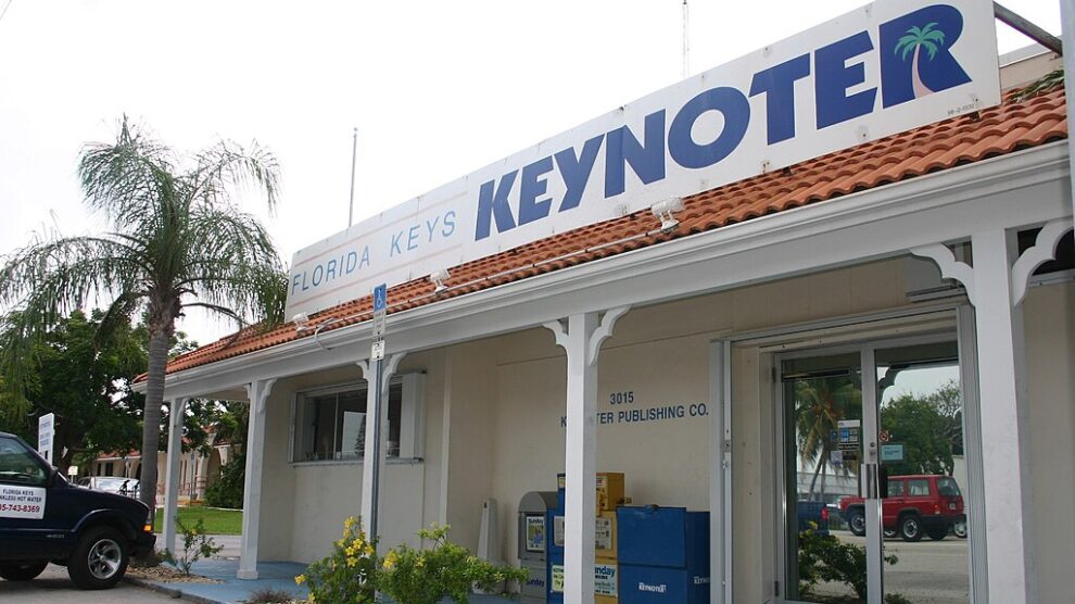 Florida Keys Keynoter building in Marathon, Florida, with a sign featuring the newspaper's name and a palm tree graphic.